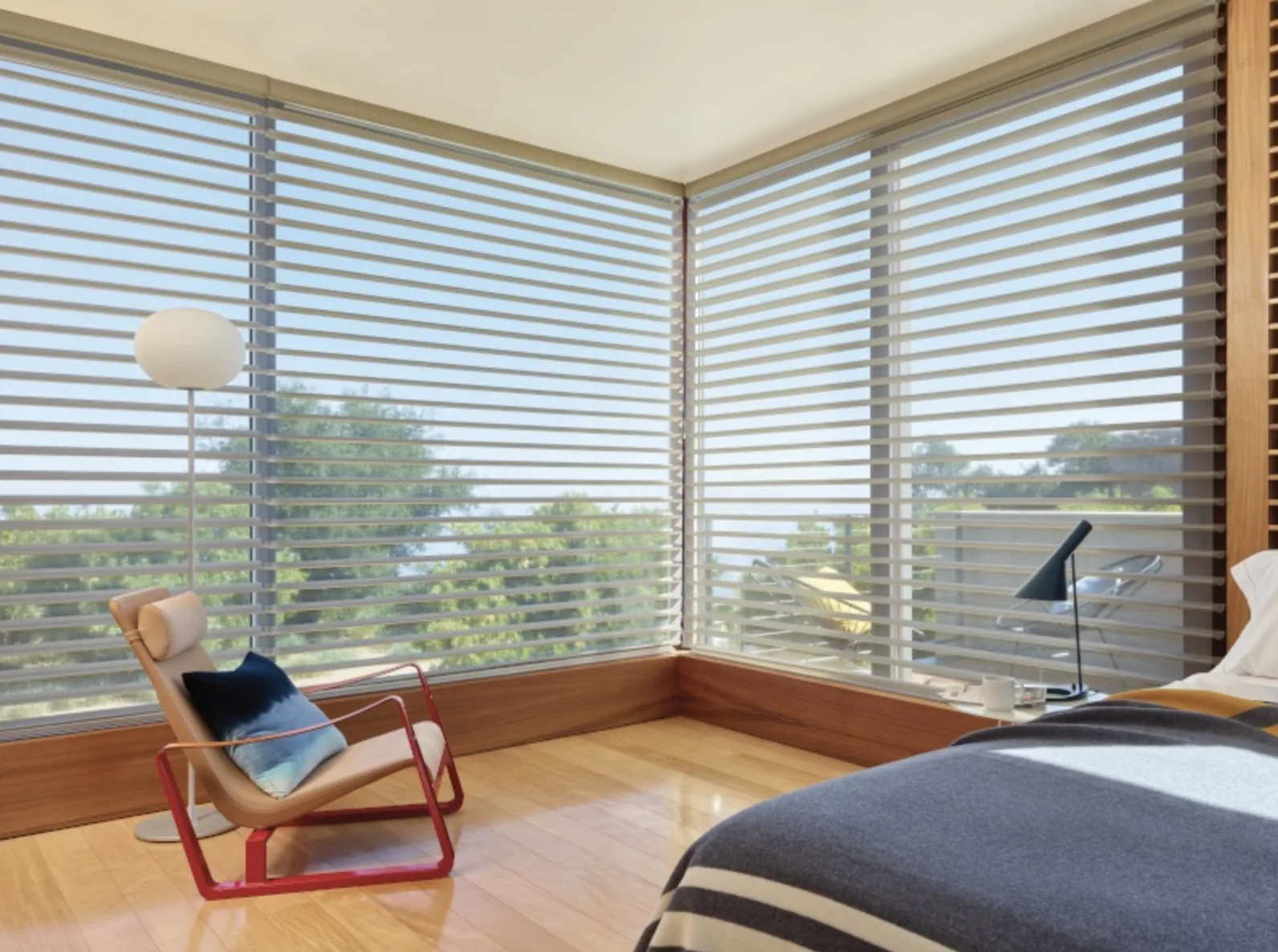 Hunter Douglas Silhouette sheer shadings filtering light on corner windows with a water view