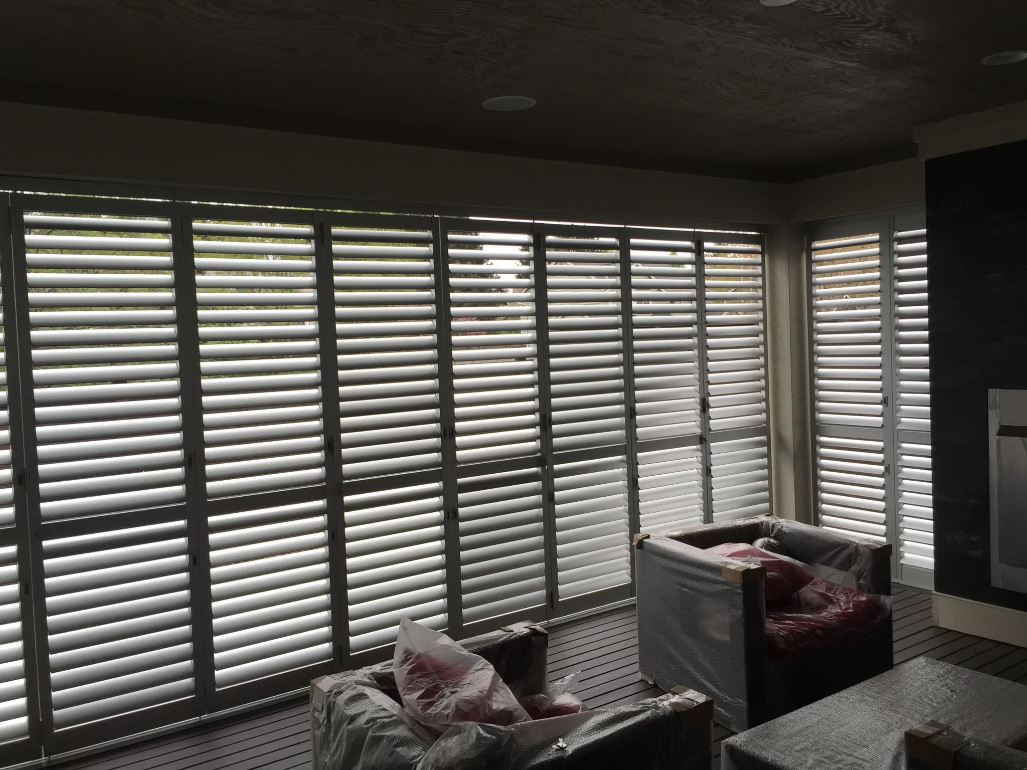 Weatherwell Elite shutters filtering daylight around a dark covered seating area