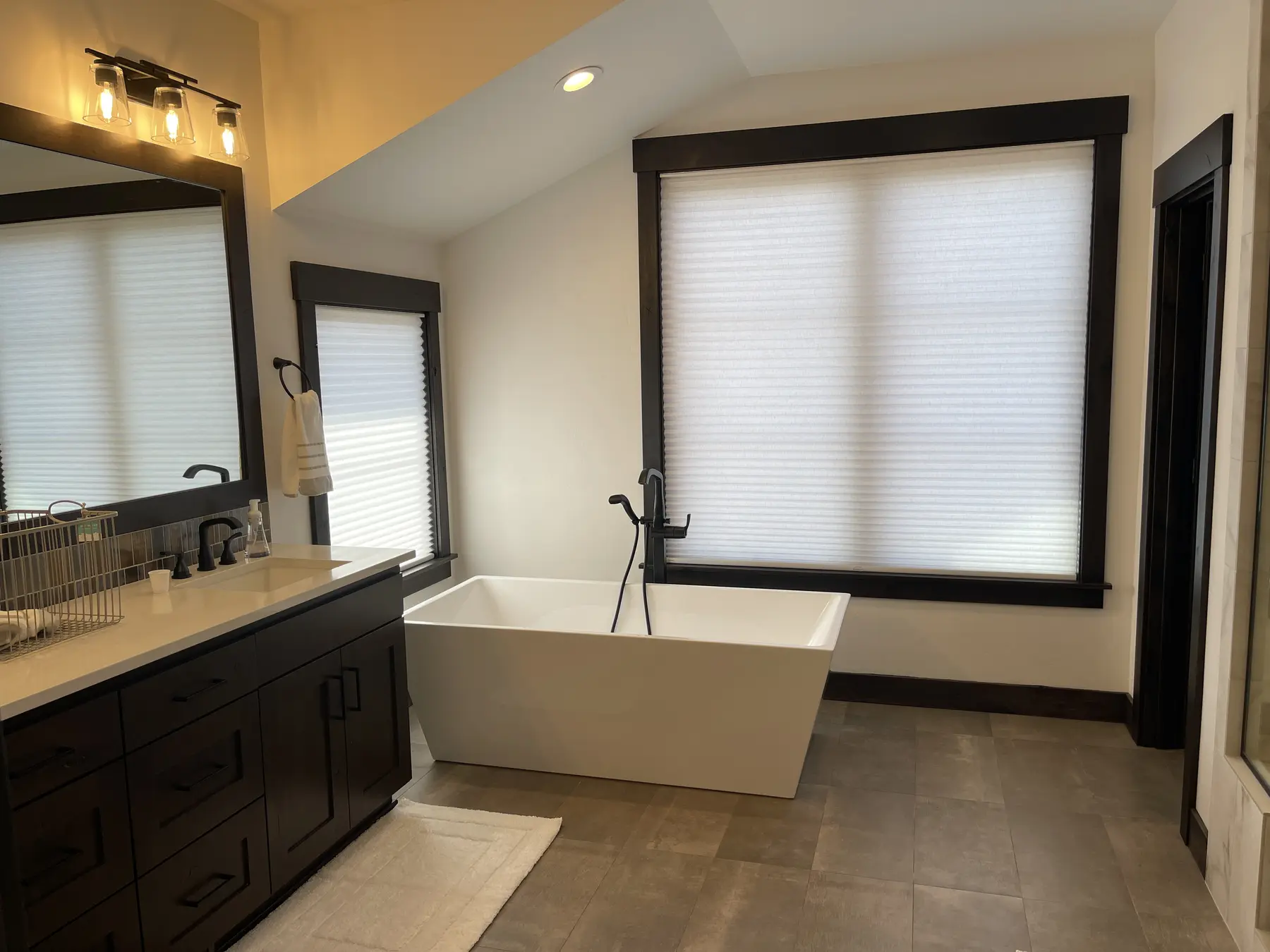 Light-filtering cellular shades installed in a modern bathroom
