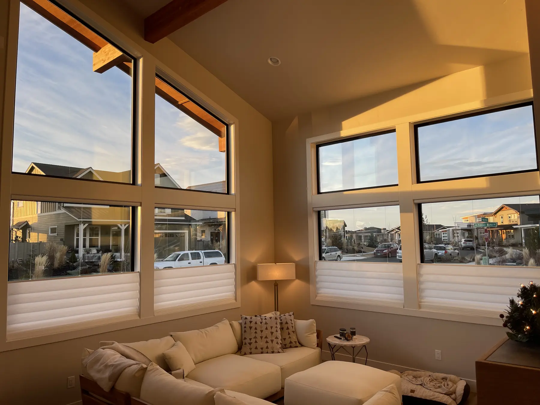 Top-down bottom-up shades filtering evening light in a living room