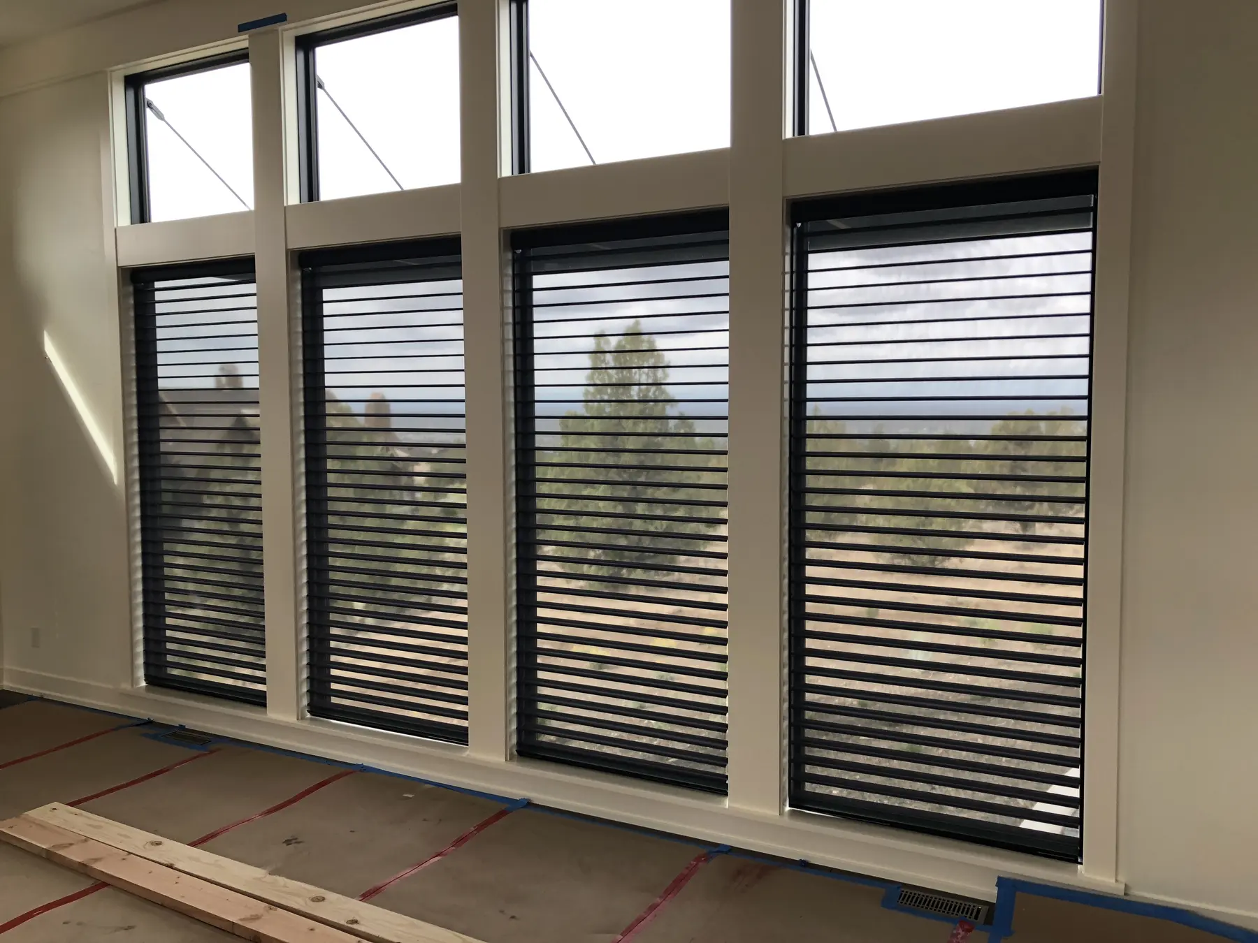 Dark horizontal blinds installed on tall windows