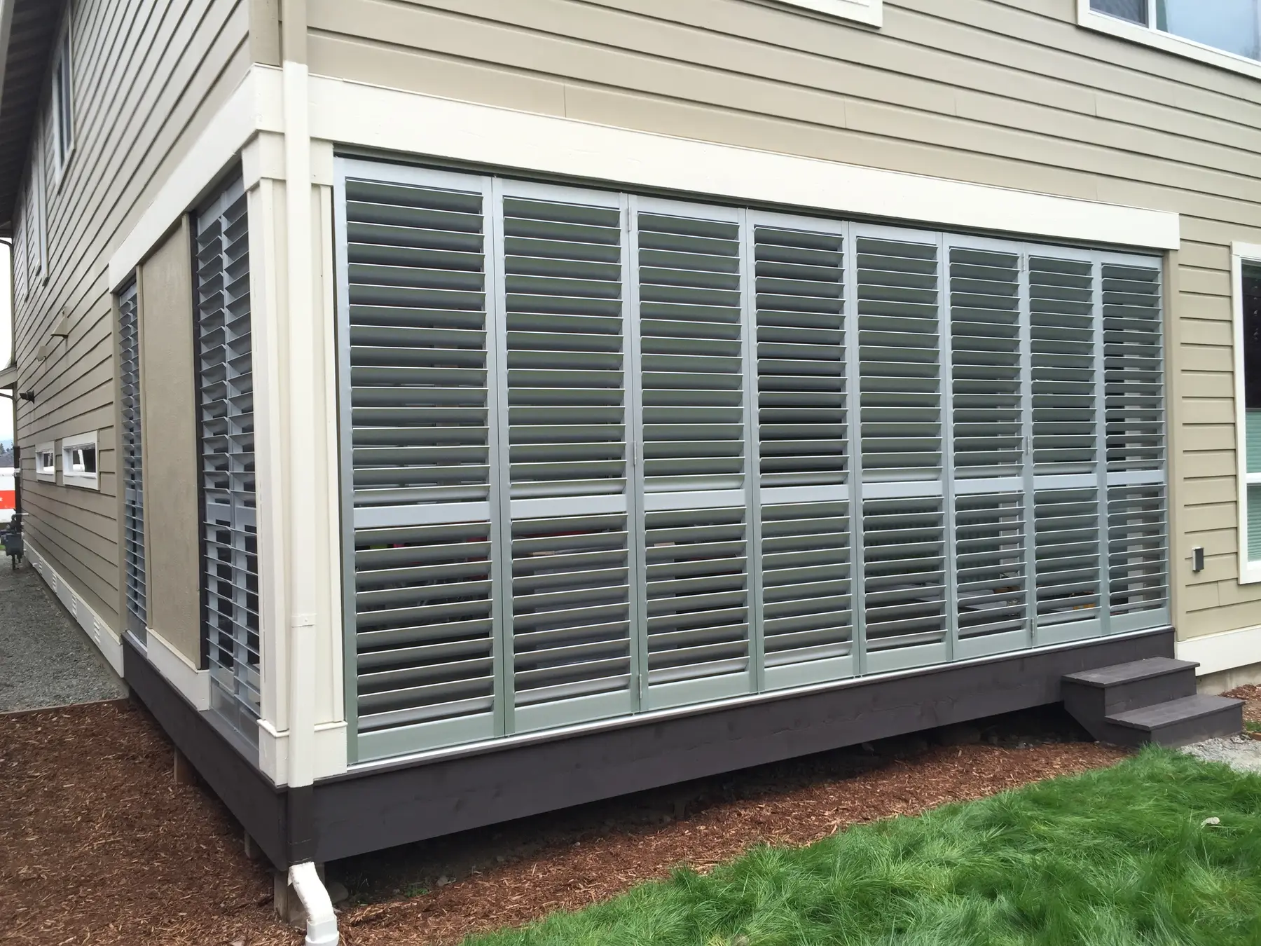 Exterior shutters enclosing a covered porch