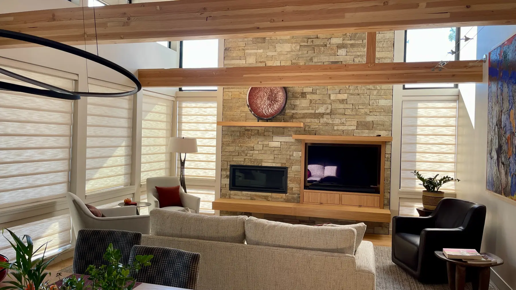 Flat panel Roman shades installed throughout a timber great room