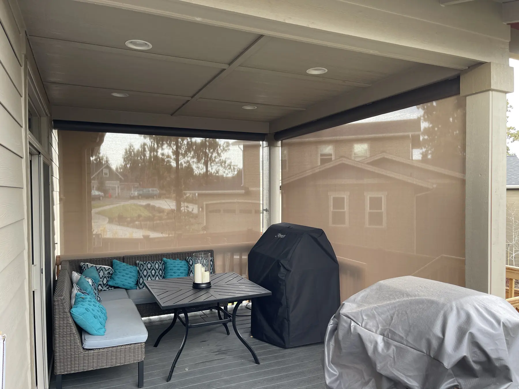Solar screen lowered across a covered patio opening