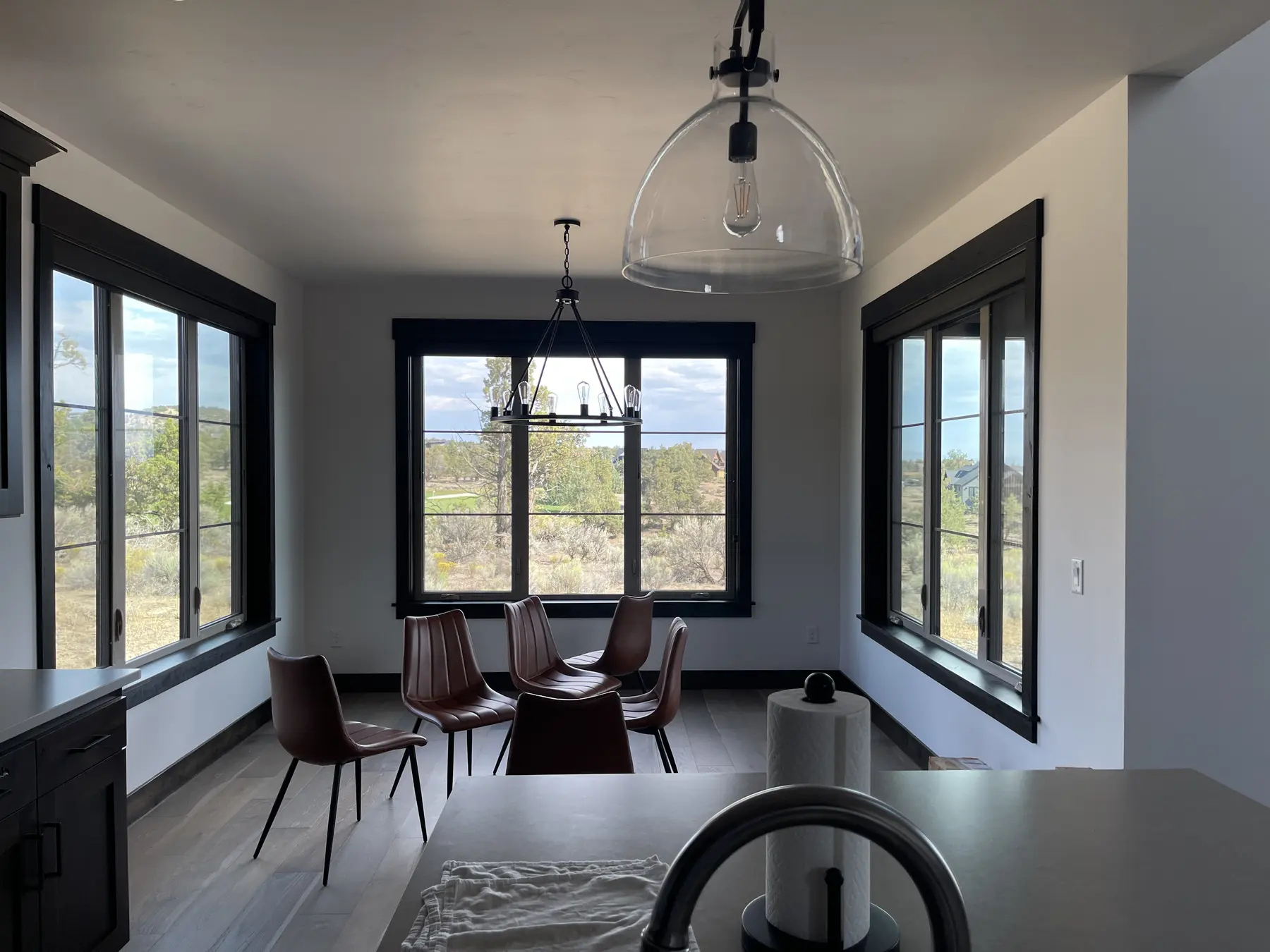 Dark solar shades controlling glare in a bright dining area