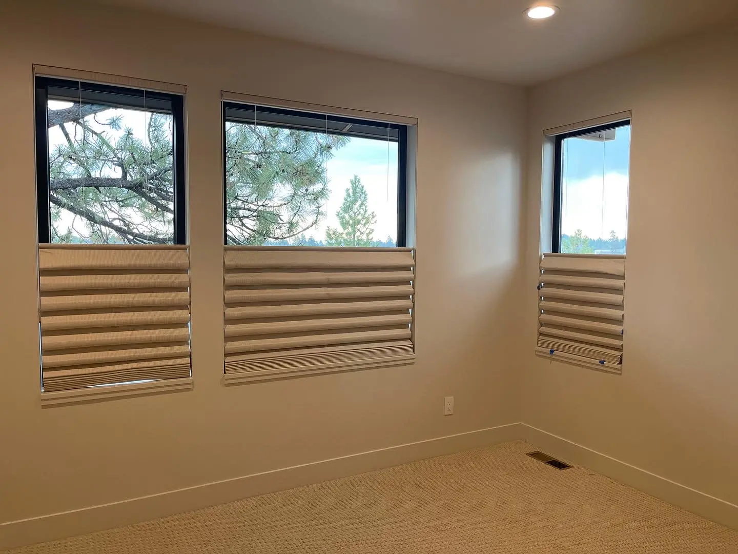Three coordinated top-down bottom-up shades in a bedroom