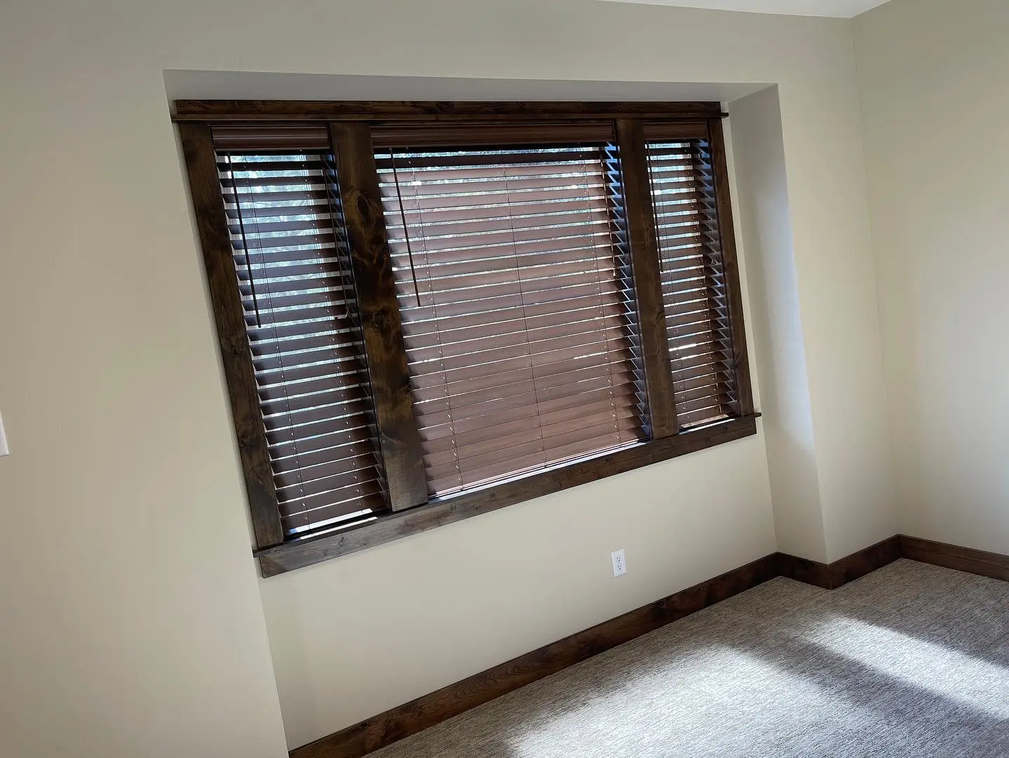 Rich wood blinds installed in a bedroom
