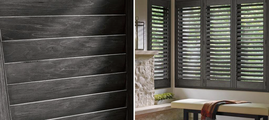 Dark aluminum interior shutters on a modern home window providing privacy and a sleek contemporary architectural look