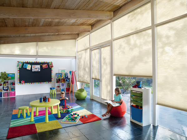Cellular honeycomb shades in a bright sunlit playroom, filtering light while keeping Idaho homes energy-efficient year-round