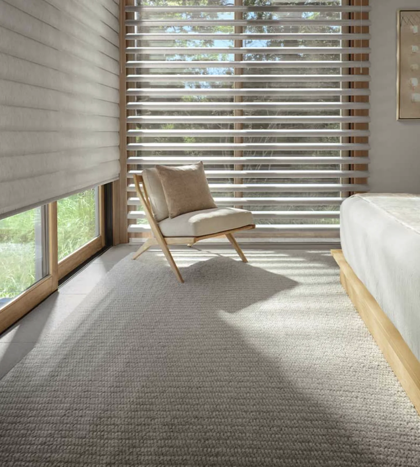 Hunter Douglas Pirouette window shadings open on a tall bedroom window, with the vanes flattened on the side window